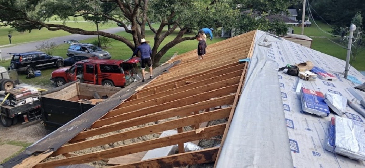 Roof framing and underlayment exposed during a roofing project